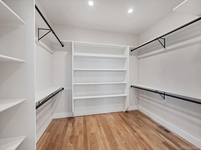 walk in closet featuring light hardwood / wood-style flooring