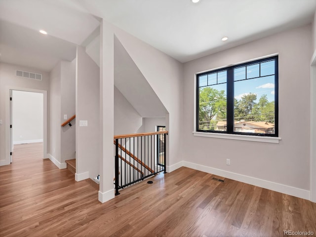 additional living space featuring light hardwood / wood-style flooring