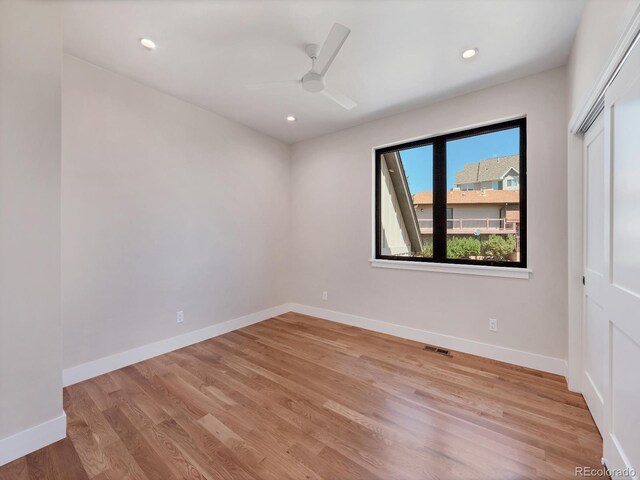 empty room with light hardwood / wood-style floors and ceiling fan