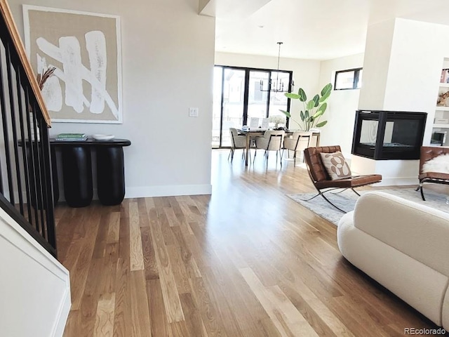 living room featuring hardwood / wood-style flooring and a chandelier