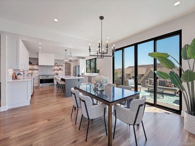 dining room featuring light hardwood / wood-style flooring and a notable chandelier