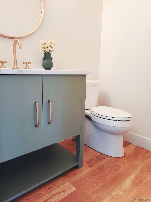 bathroom with sink, hardwood / wood-style floors, and toilet