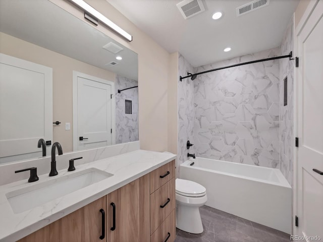 full bathroom with tiled shower / bath, vanity, and toilet