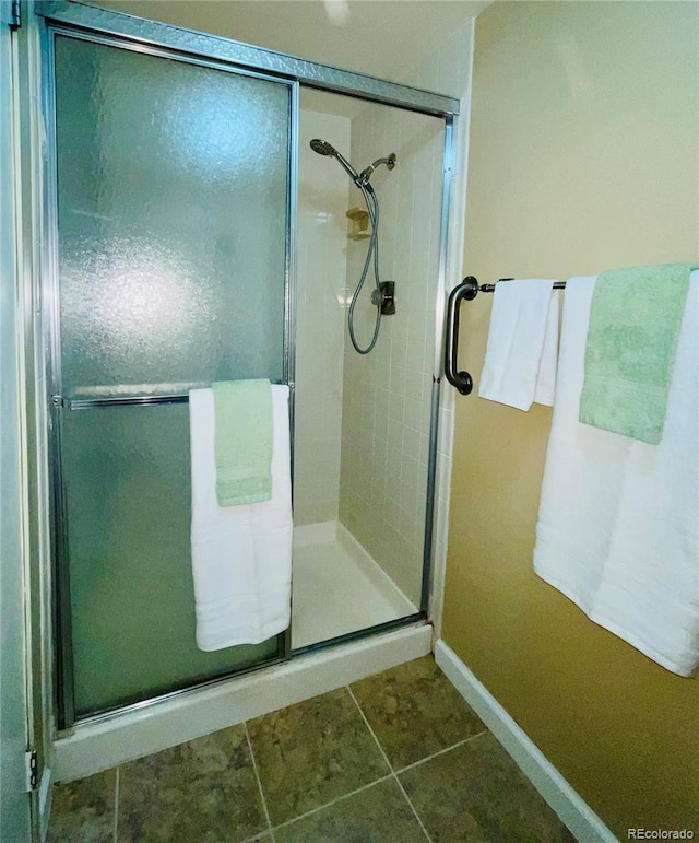 bathroom featuring a shower with shower door