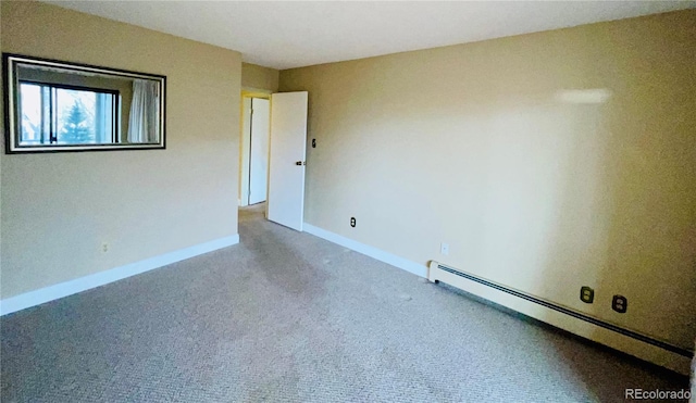 carpeted spare room with a baseboard radiator