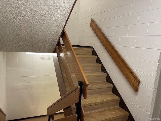 stairway featuring vaulted ceiling