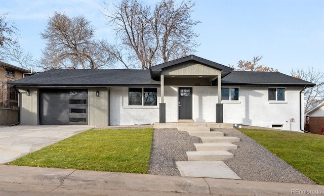 view of front of property with a garage and a front lawn