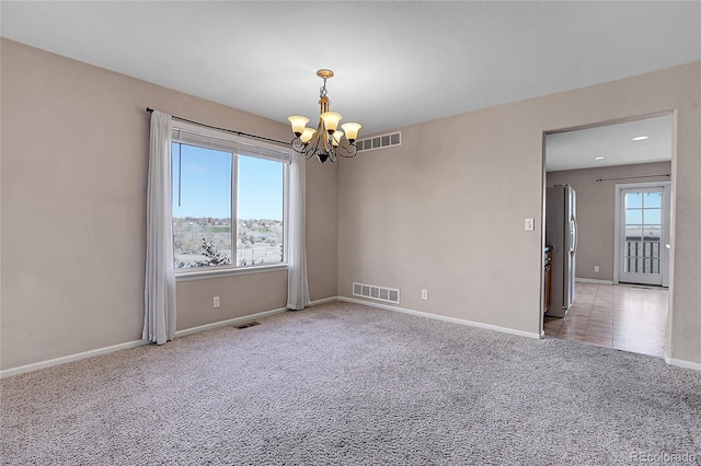 unfurnished room featuring carpet floors and a notable chandelier