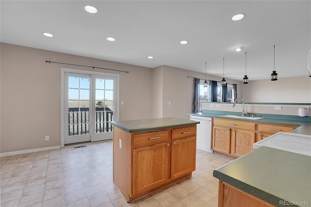 kitchen featuring dishwasher, a kitchen island, decorative light fixtures, and sink