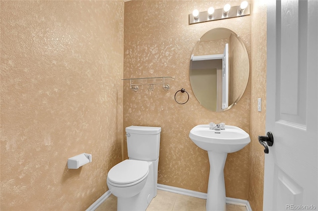 bathroom featuring sink, tile patterned flooring, and toilet