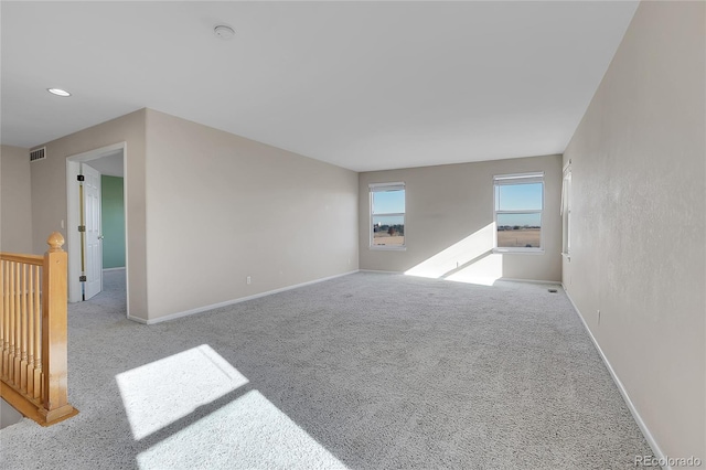 unfurnished room featuring light colored carpet