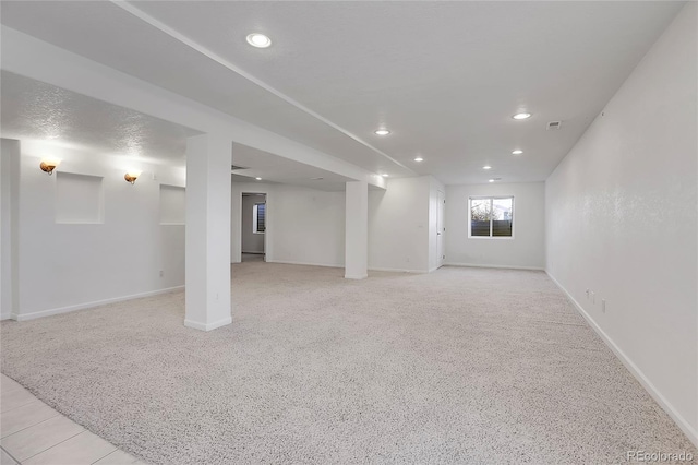 basement featuring light colored carpet