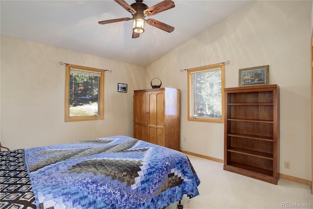 bedroom with ceiling fan, light carpet, and vaulted ceiling