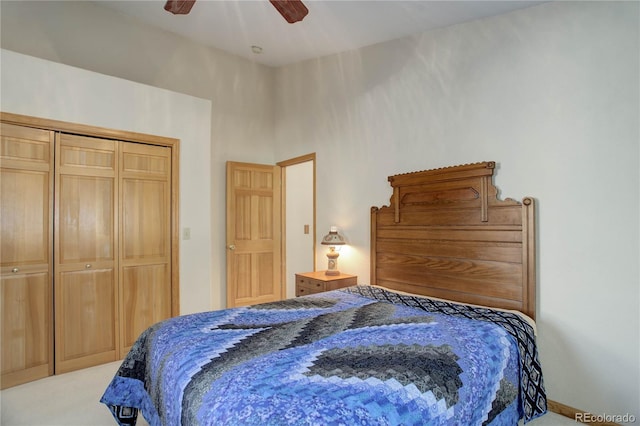 bedroom with ceiling fan, light carpet, and a closet