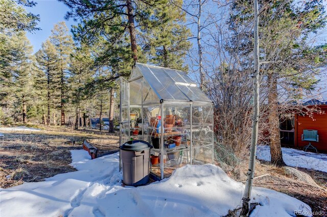 snowy yard with an outbuilding