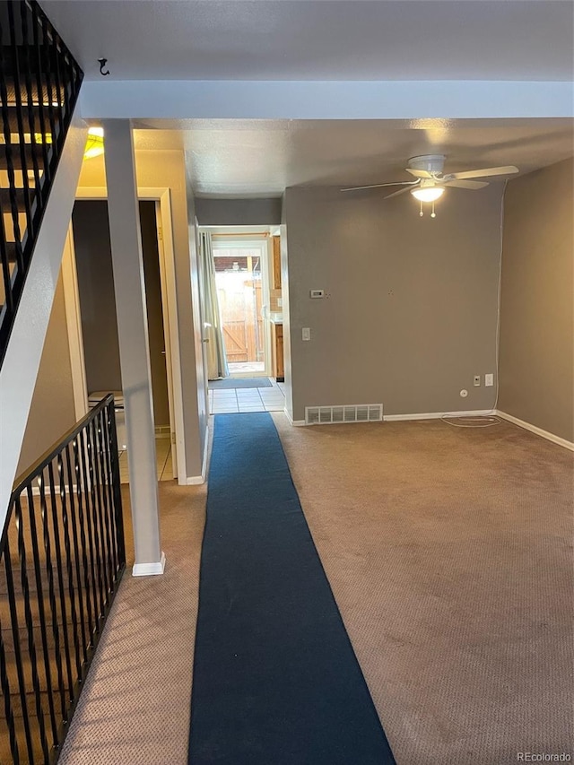 hallway featuring light colored carpet