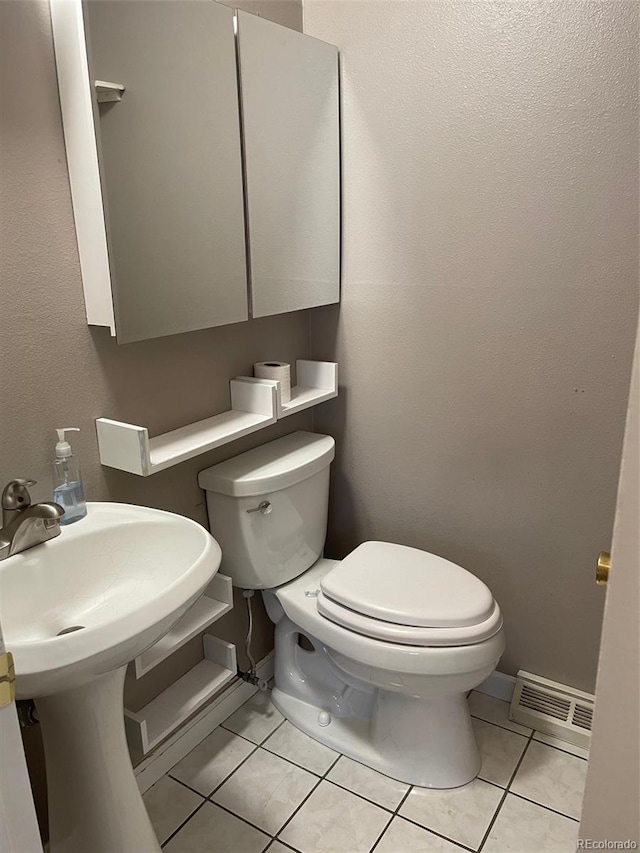 bathroom with sink, tile patterned floors, and toilet