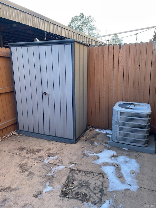 view of patio / terrace featuring cooling unit and a storage unit