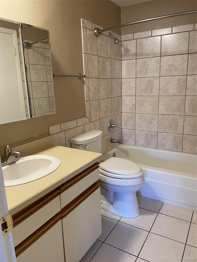 full bathroom with vanity, toilet, tiled shower / bath combo, and tile patterned flooring