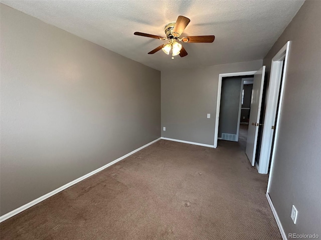 interior space featuring ceiling fan, a textured ceiling, and carpet