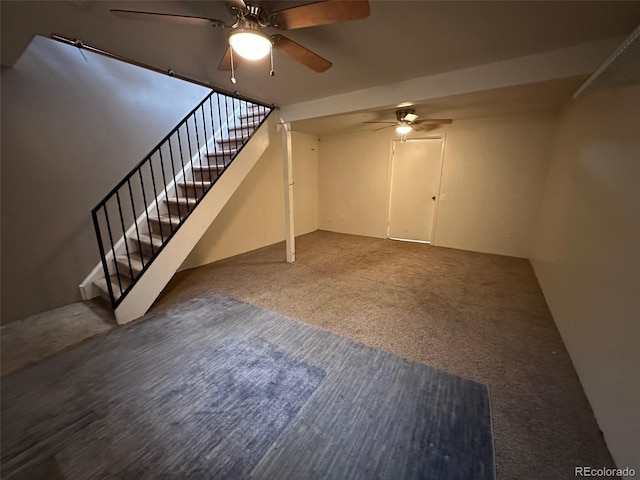 unfurnished living room featuring ceiling fan and dark carpet