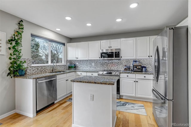 5075 Weeping Willow Cir, Highlands Ranch, CO 80130 - kitchen with appliances with stainless steel finishes, white cabinetry, decorative backsplash, and recessed lighting