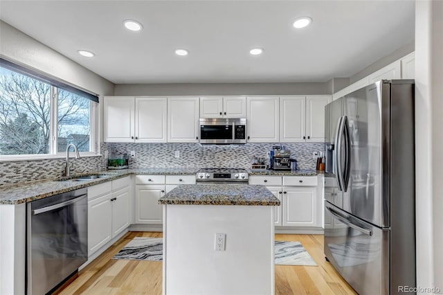 5075 Weeping Willow Cir, Highlands Ranch, CO 80130 - kitchen with appliances with stainless steel finishes, a kitchen island, white cabinetry, stone counters, and recessed lighting