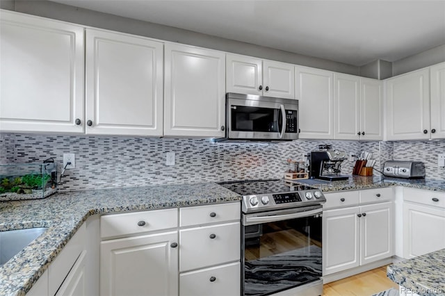 5075 Weeping Willow Cir, Highlands Ranch, CO 80130 - kitchen with stainless steel appliances, light stone counters, and white cabinetry