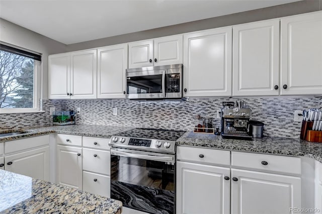 5075 Weeping Willow Cir, Highlands Ranch, CO 80130 - kitchen featuring appliances with stainless steel finishes, white cabinetry, and backsplash