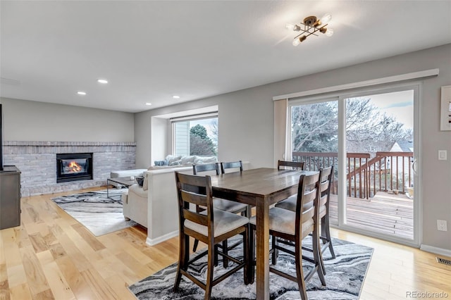 5075 Weeping Willow Cir, Highlands Ranch, CO 80130 - dining space featuring light wood-style floors, recessed lighting, and a fireplace