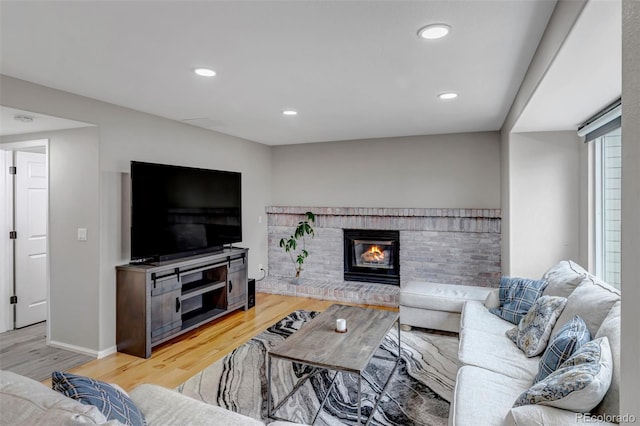 5075 Weeping Willow Cir, Highlands Ranch, CO 80130 - living area with light wood-type flooring, recessed lighting, and a brick fireplace