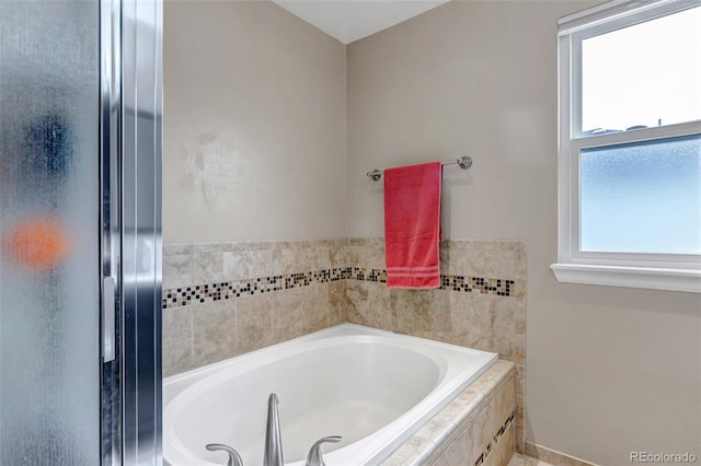 5075 Weeping Willow Cir, Highlands Ranch, CO 80130 - bathroom featuring a garden tub and baseboards