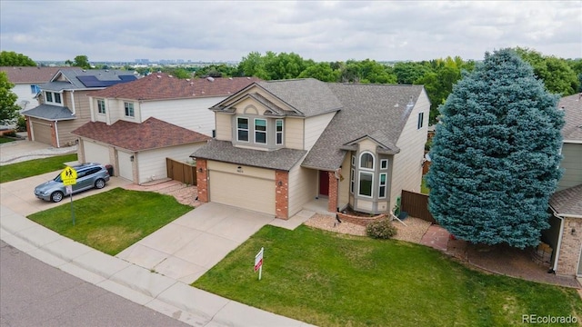 5075 Weeping Willow Cir, Highlands Ranch, CO 80130 - view of front of house featuring concrete driveway, brick siding, a garage, and roof with shingles