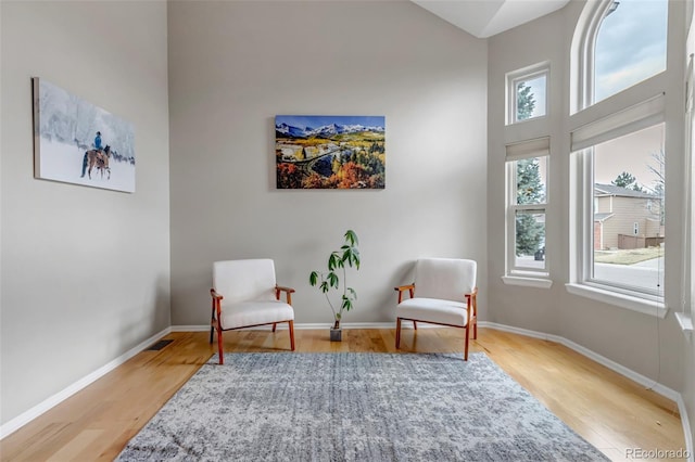 5075 Weeping Willow Cir, Highlands Ranch, CO 80130 - living area with healthy amount of natural light, wood finished floors, and a towering ceiling