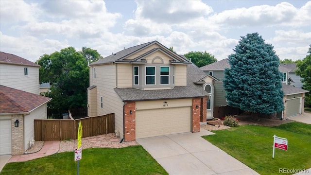 5075 Weeping Willow Cir, Highlands Ranch, CO 80130 - view of front of home featuring brick siding, concrete driveway, an attached garage, and a shingled roof