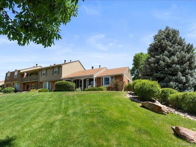 7101 W Yale Ave Unit 1305, Denver, CO 80227 - rear view of house featuring a yard and brick siding