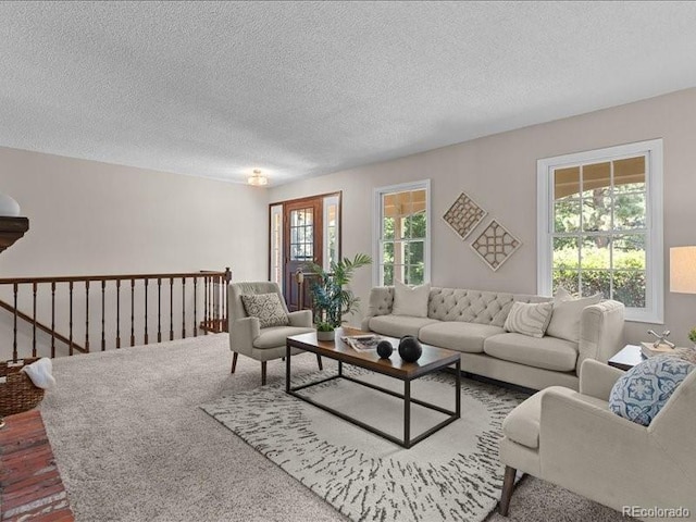 7101 W Yale Ave Unit 1305, Denver, CO 80227 - living area featuring plenty of natural light, a textured ceiling, and wood finished floors