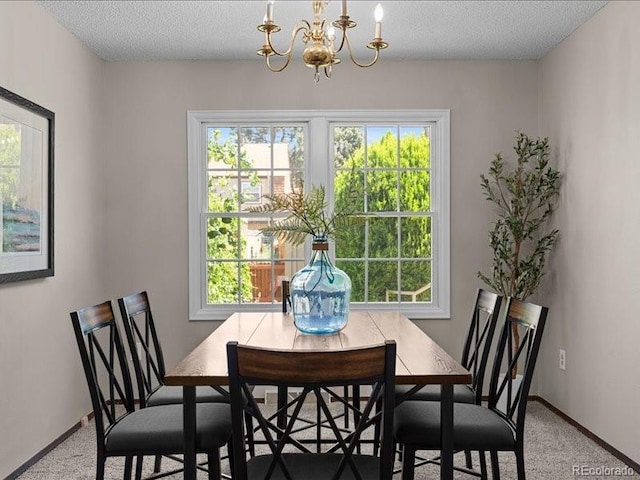 7101 W Yale Ave Unit 1305, Denver, CO 80227 - dining space featuring a chandelier, carpet, plenty of natural light, and a textured ceiling