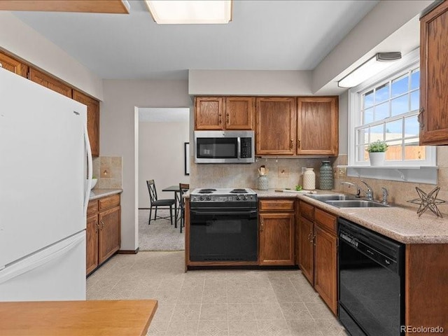 7101 W Yale Ave Unit 1305, Denver, CO 80227 - kitchen featuring stainless steel microwave, black dishwasher, freestanding refrigerator, electric stove, and backsplash