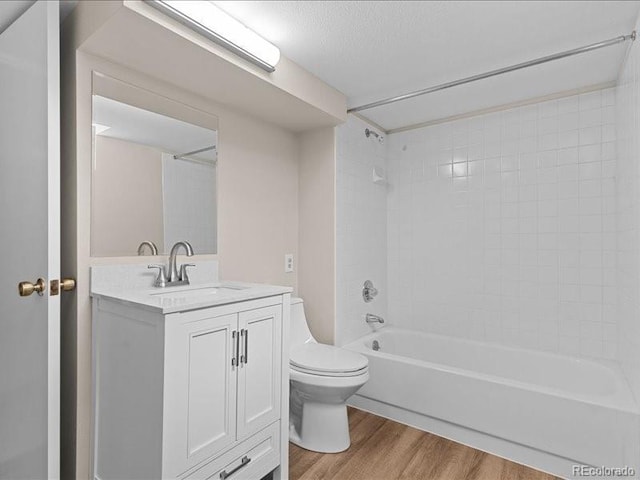 7101 W Yale Ave Unit 1305, Denver, CO 80227 - bathroom featuring wood finished floors, vanity, shower / bathtub combination, and a textured ceiling
