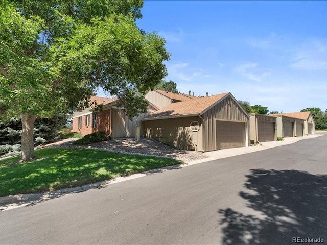 7101 W Yale Ave Unit 1305, Denver, CO 80227 - view of front of house with board and batten siding and a front lawn