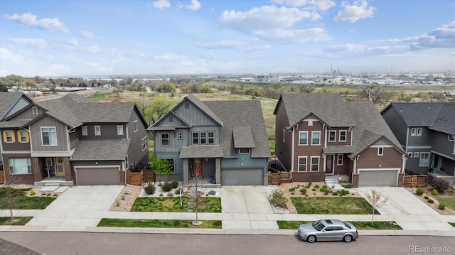craftsman-style house featuring concrete driveway, a residential view, and a garage