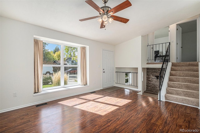 unfurnished living room with hardwood / wood-style flooring and ceiling fan