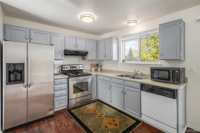 kitchen featuring appliances with stainless steel finishes, dark hardwood / wood-style floors, sink, and gray cabinets