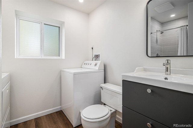 bathroom featuring washer / dryer, toilet, vanity, and wood-type flooring