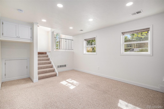 basement featuring light colored carpet