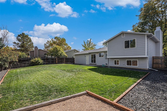 rear view of property featuring a yard