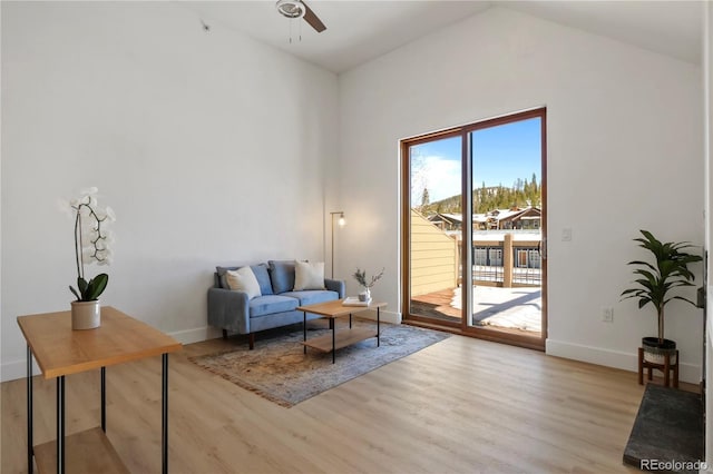 sitting room featuring vaulted ceiling, ceiling fan, and light hardwood / wood-style floors