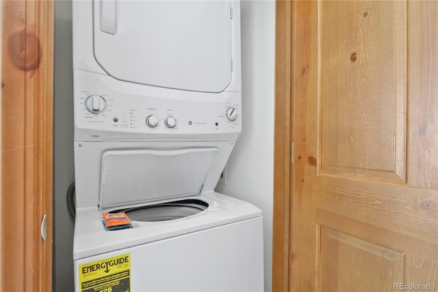 washroom featuring stacked washer / drying machine