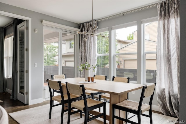 3473 Beeler St, Denver, CO 80238 - dining room featuring healthy amount of natural light, wood finished floors, and a chandelier